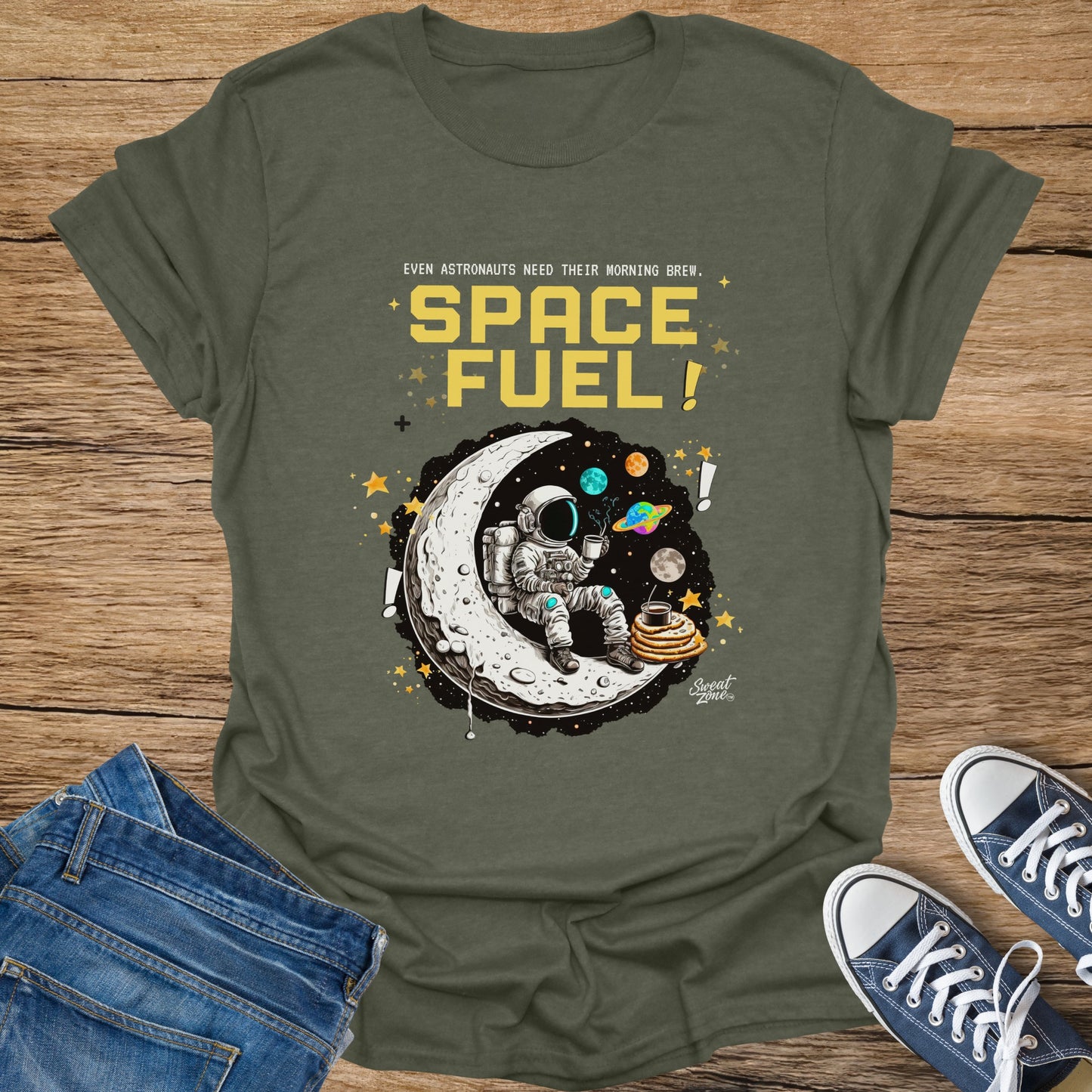 Olive t-shirt with graphic of astronaut on moon with coffee and pancakes, text "SPACE FUEL!".