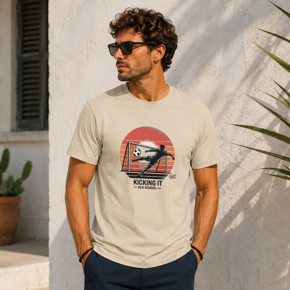 Kicking It Old School soccer graphic on a tan t-shirt.