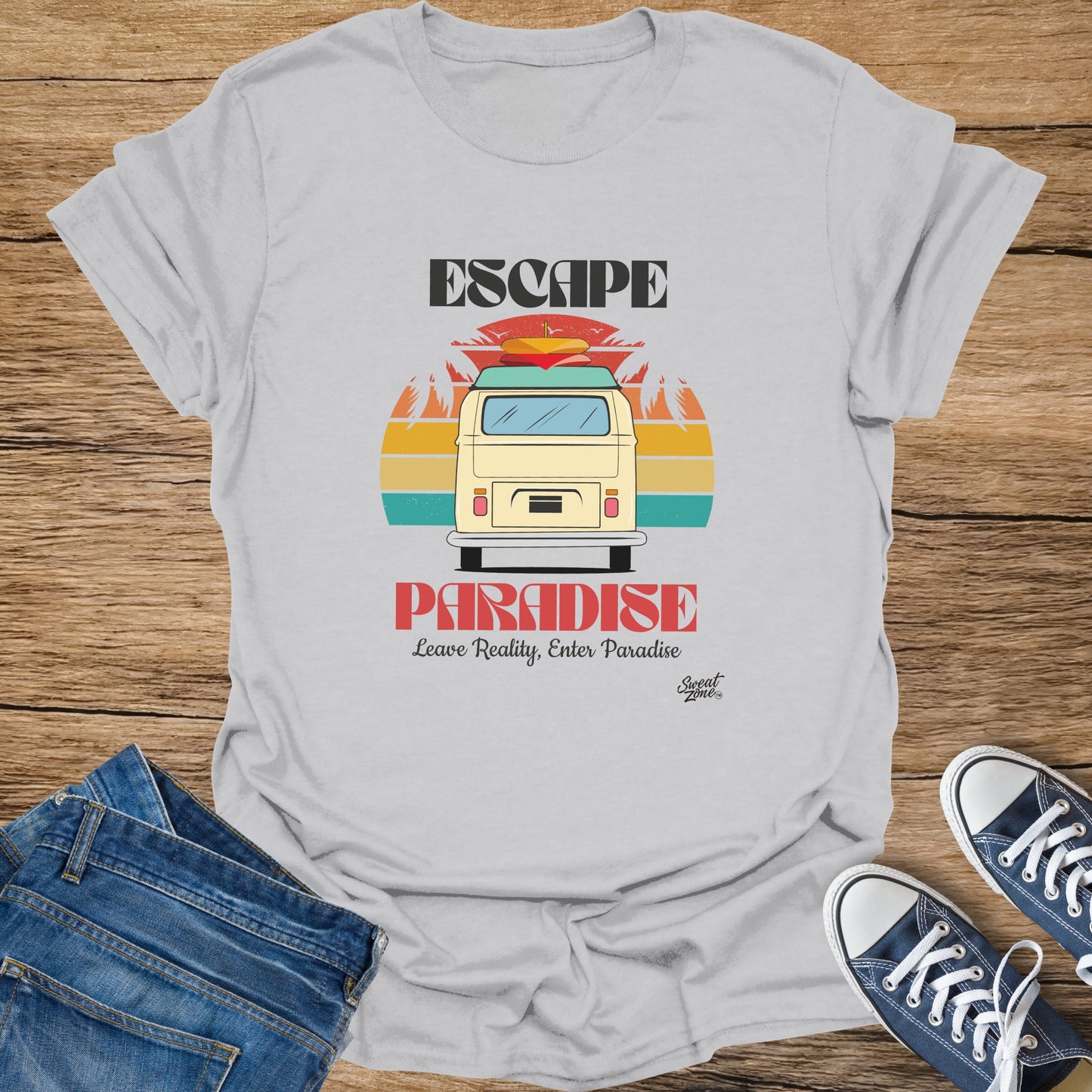 White t-shirt with "ESCAPE PARADISE" text, vintage van, and palm trees graphic.