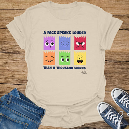 T-shirt with six emotion faces and text "A FACE SPEAKS LOUDER THAN A THOUSAND WORDS."