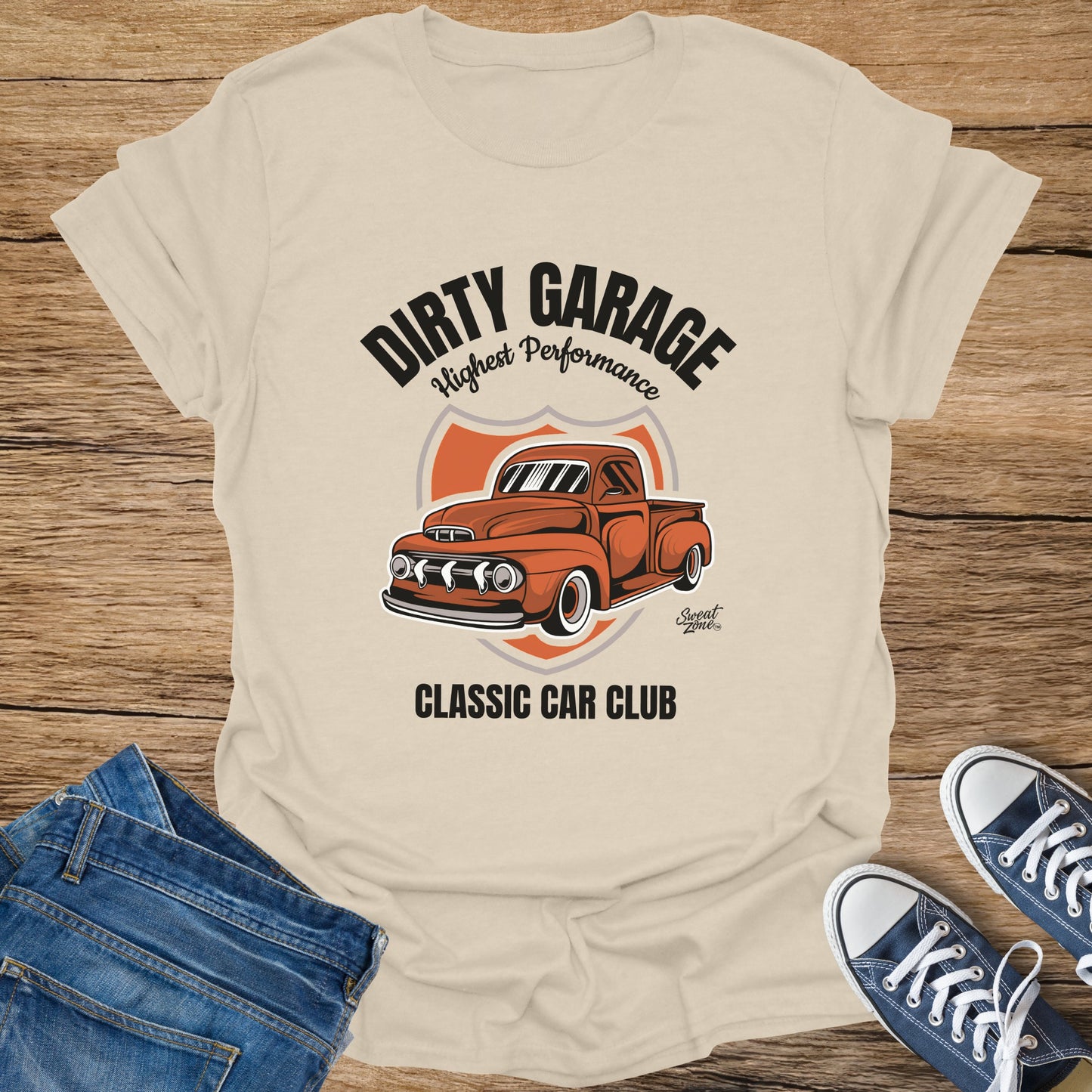 Cream t-shirt with vintage orange truck graphic for "Dirty Garage Classic Car Club."