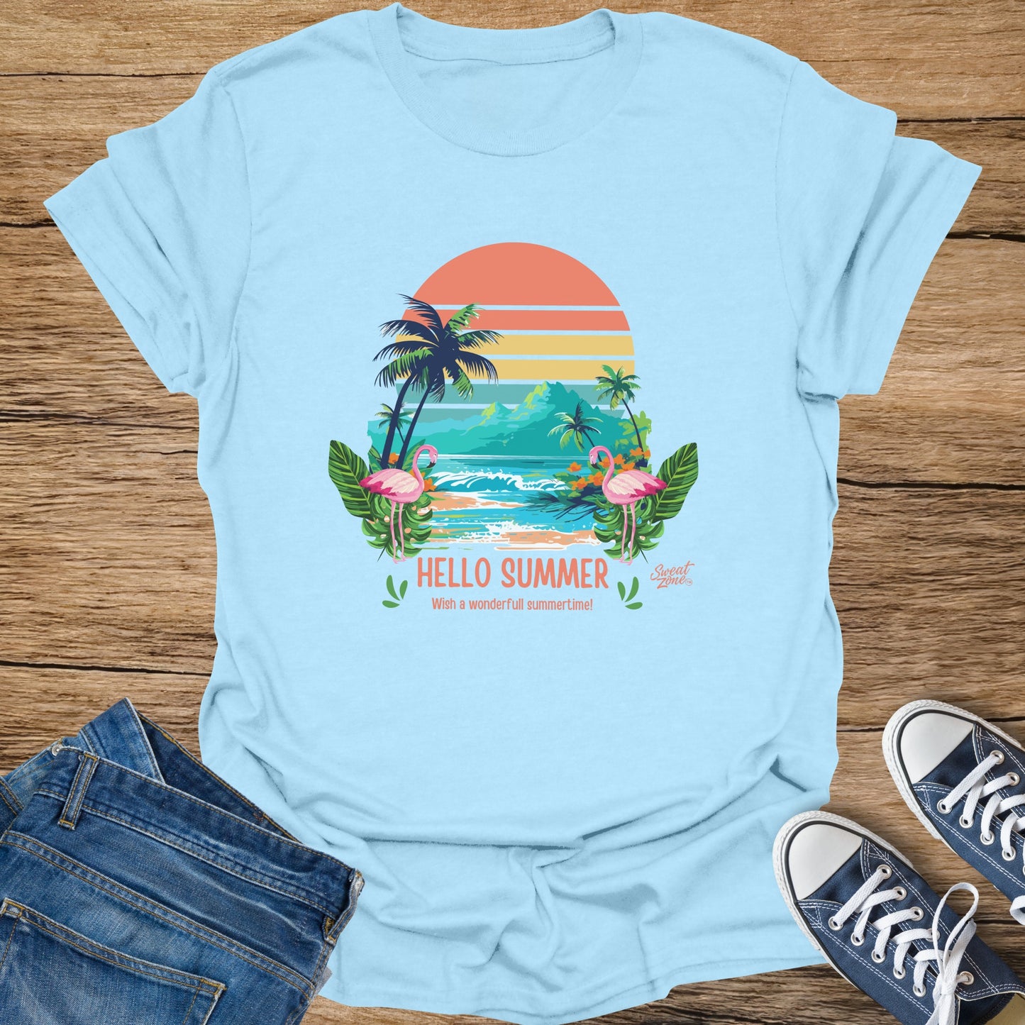 Light blue t-shirt with flamingos, palm trees, beach scene and "Hello Summer" text.