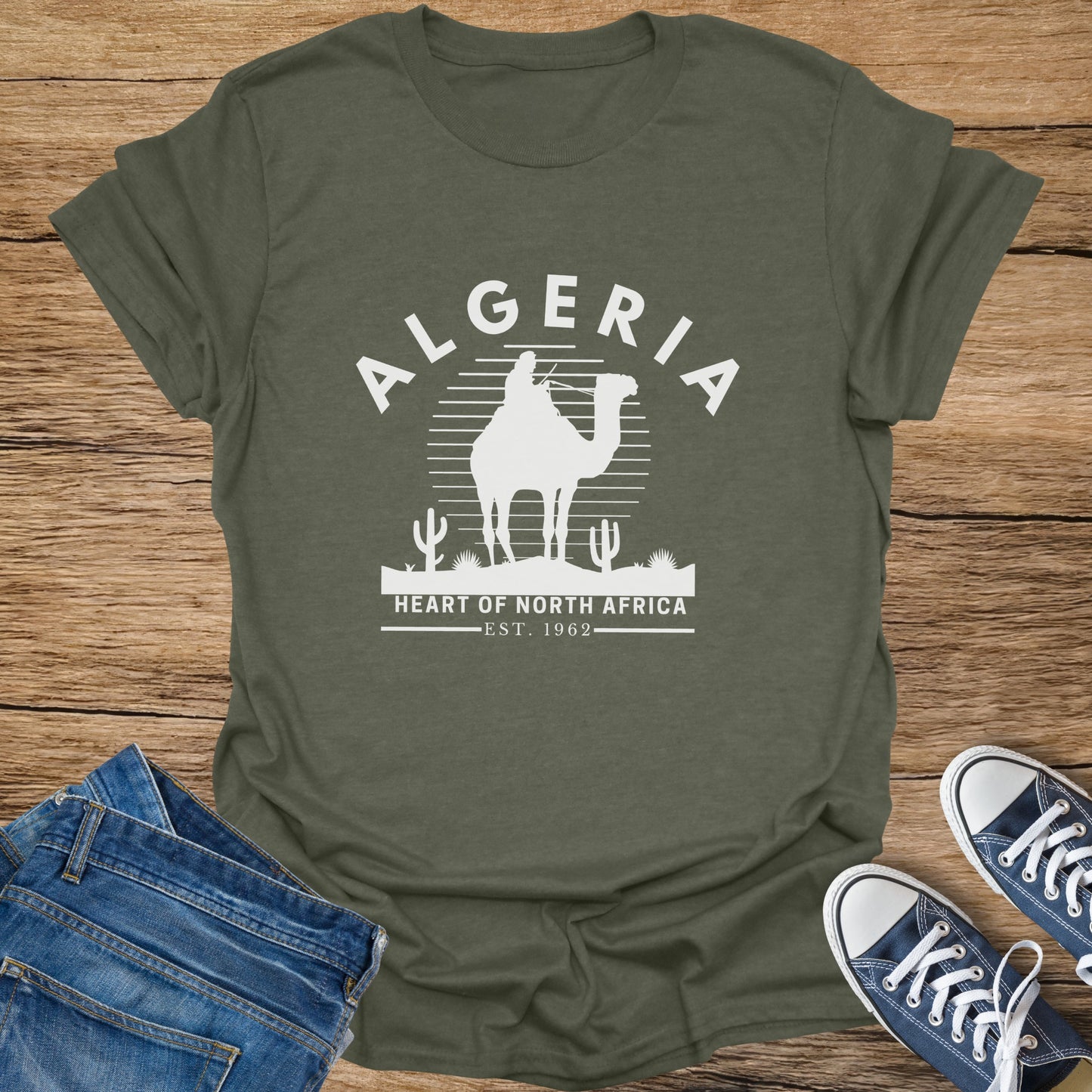 Olive green t-shirt with "ALGERIA" text and camel graphic, "EST. 1962".
