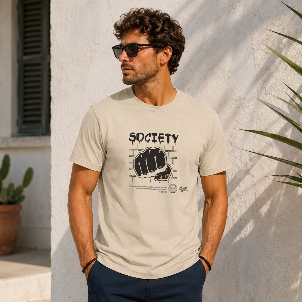 Light tan t-shirt with \"SOCIETY\" text and a fist graphic on brick background.