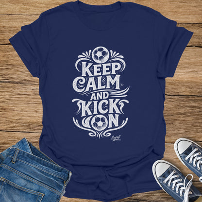 Navy t-shirt with white "Keep Calm And Kick On" text and soccer ball artwork.