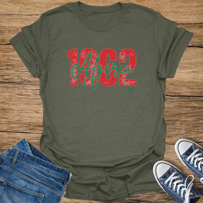 Green t-shirt with distressed red and green "1962 Algeria" graphic.