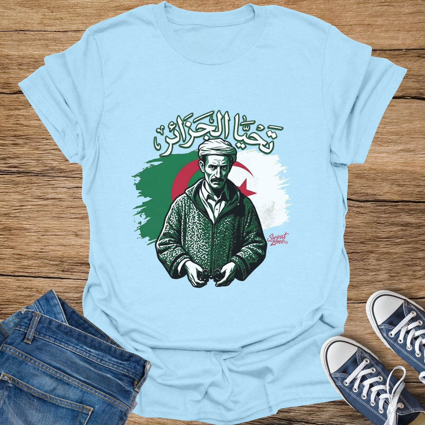 Light blue t-shirt with illustration of man and Algerian flag.
