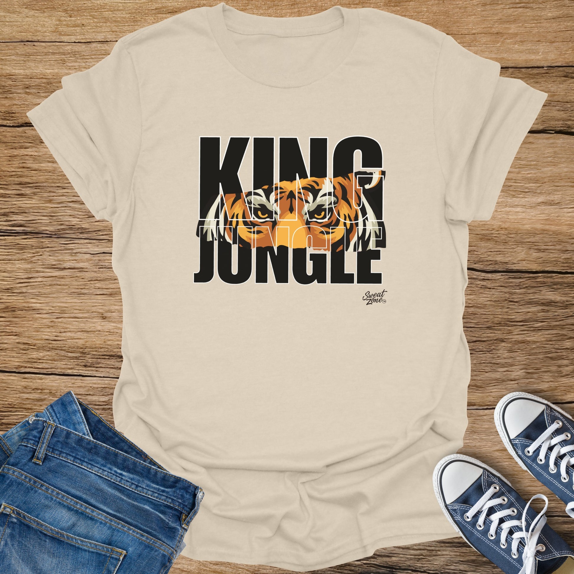 Cream t-shirt with "KING JUNGLE" text and tiger eyes graphic.