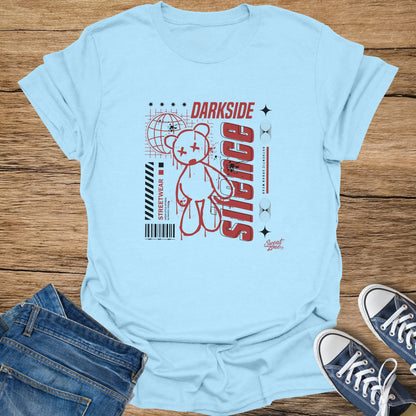 Light blue t-shirt with a graphic of a red teddy bear, globe, and "DARK SIDE" text.