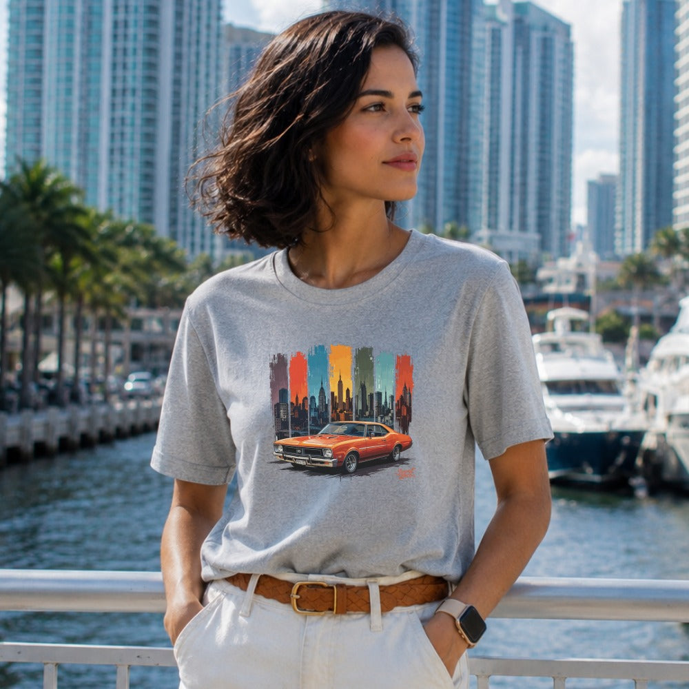 T-shirt with vintage car and city skyline graphic on colorful vertical stripes.
