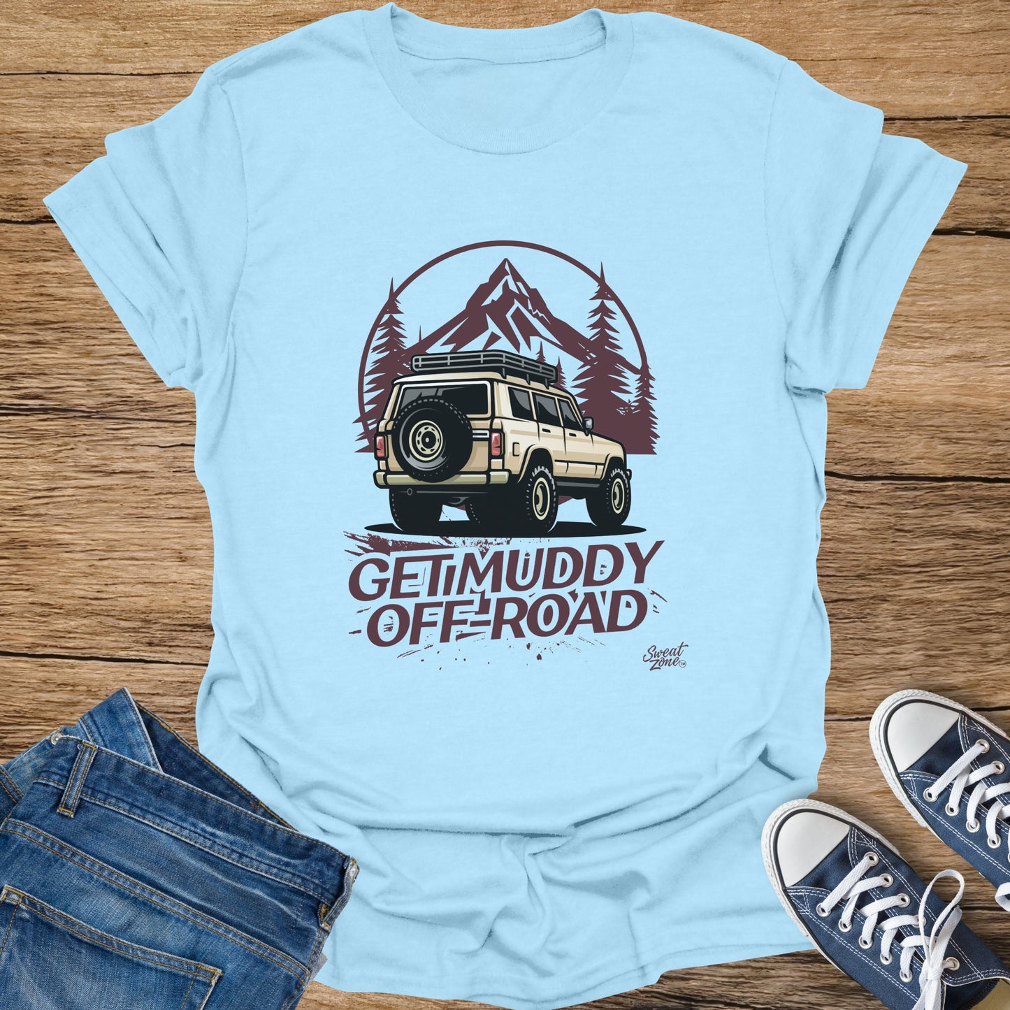 Light blue t-shirt with illustration of an off-road vehicle and "Get Muddy Off-Road" text.