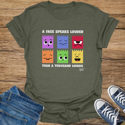 T-shirt with six colorful squares showing different emoji faces and text.