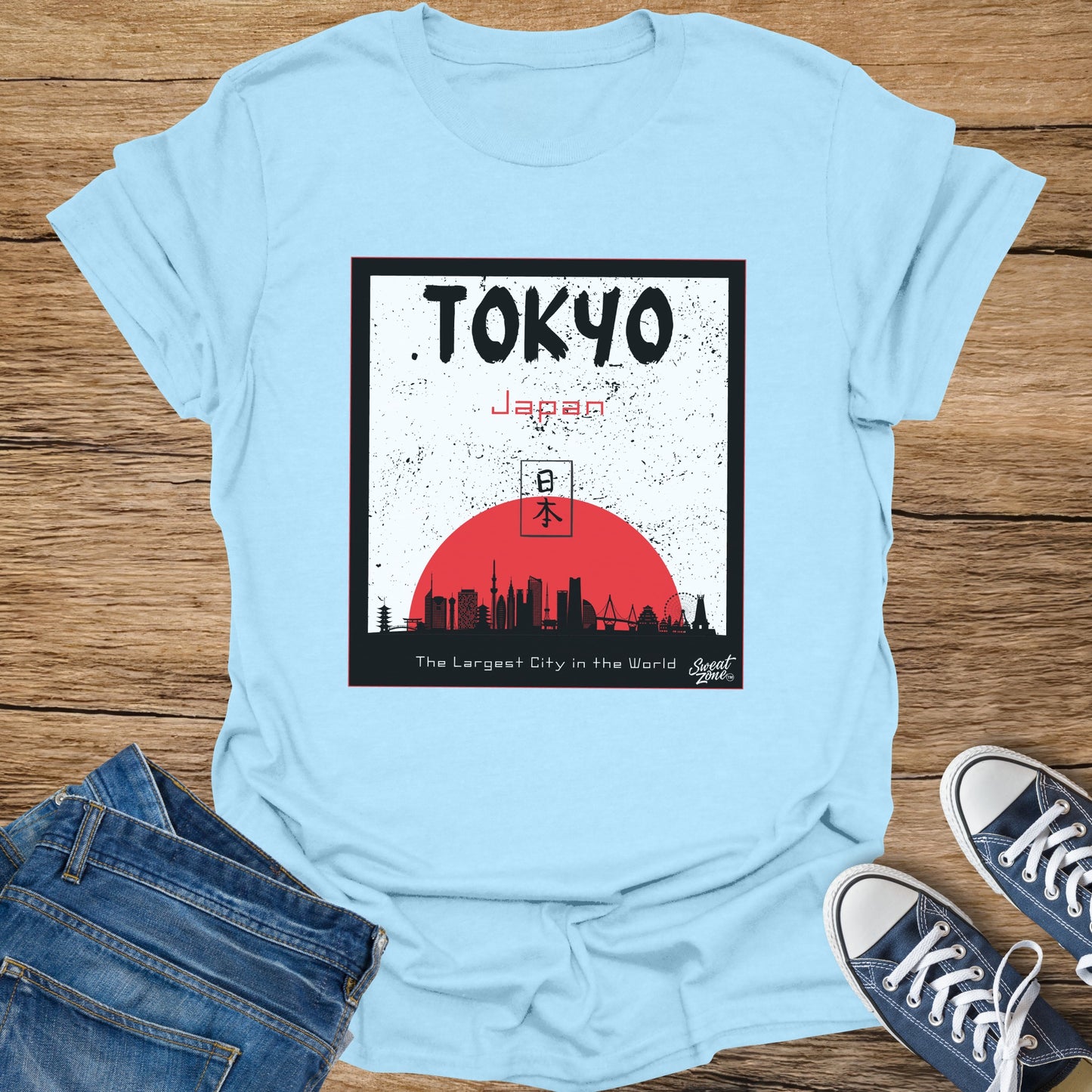 Light blue t-shirt with a graphic of Tokyo skyline, Japan, and kanji.