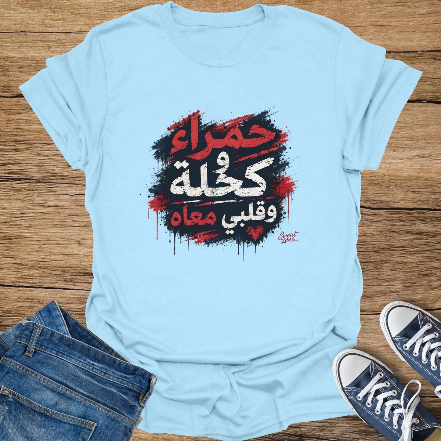 Light blue t-shirt with Arabic text and brush stroke graphic.