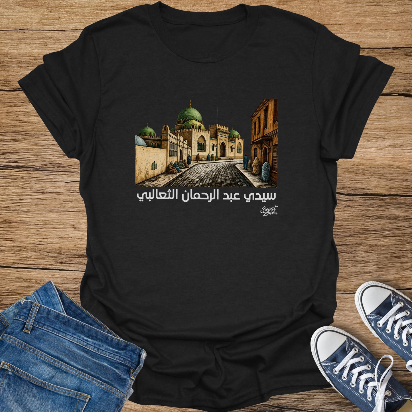Black t-shirt with Arabic text and illustration of a mosque and street.