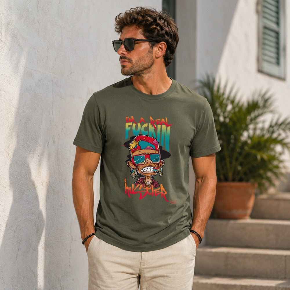 Green t-shirt with cartoon character graphic and text "I'M A REAL FUCKIN HUSTLER".