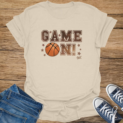 Cream t-shirt with "GAME ON!" and basketball graphic.