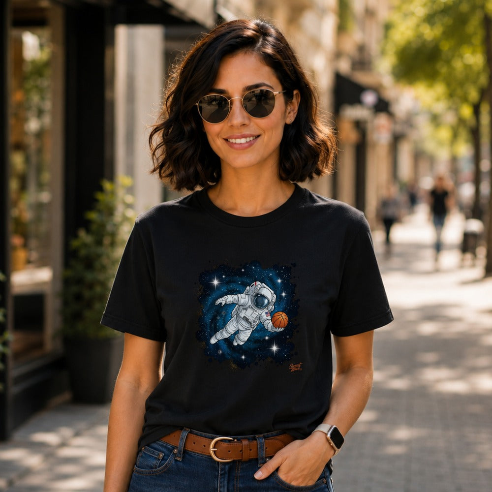 Black t-shirt featuring an astronaut holding a basketball among stars and galaxies.