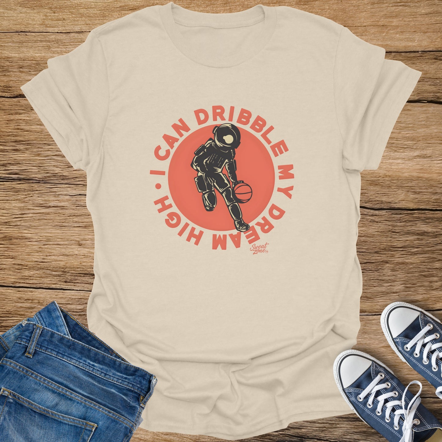 T-shirt with astronaut dribbling basketball graphic and text "I CAN DRIBBLE MY DREAM HIGH."