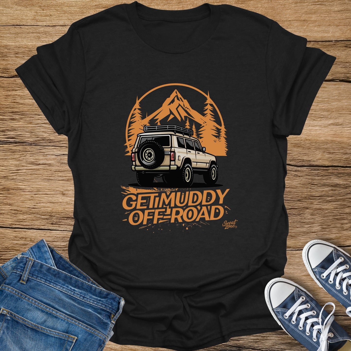 Black t-shirt with cream off-road vehicle graphic and "Get Muddy Off-Road" text.