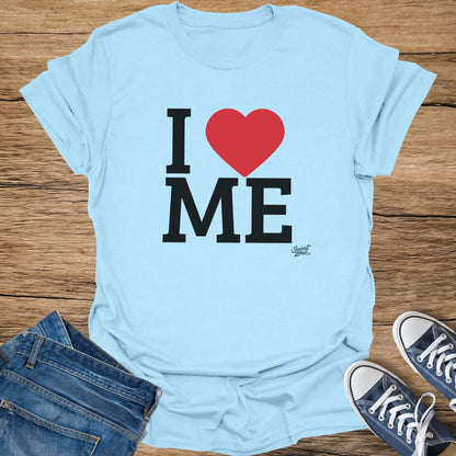 Light blue t-shirt with black text "I ❤️ ME" and a small logo.