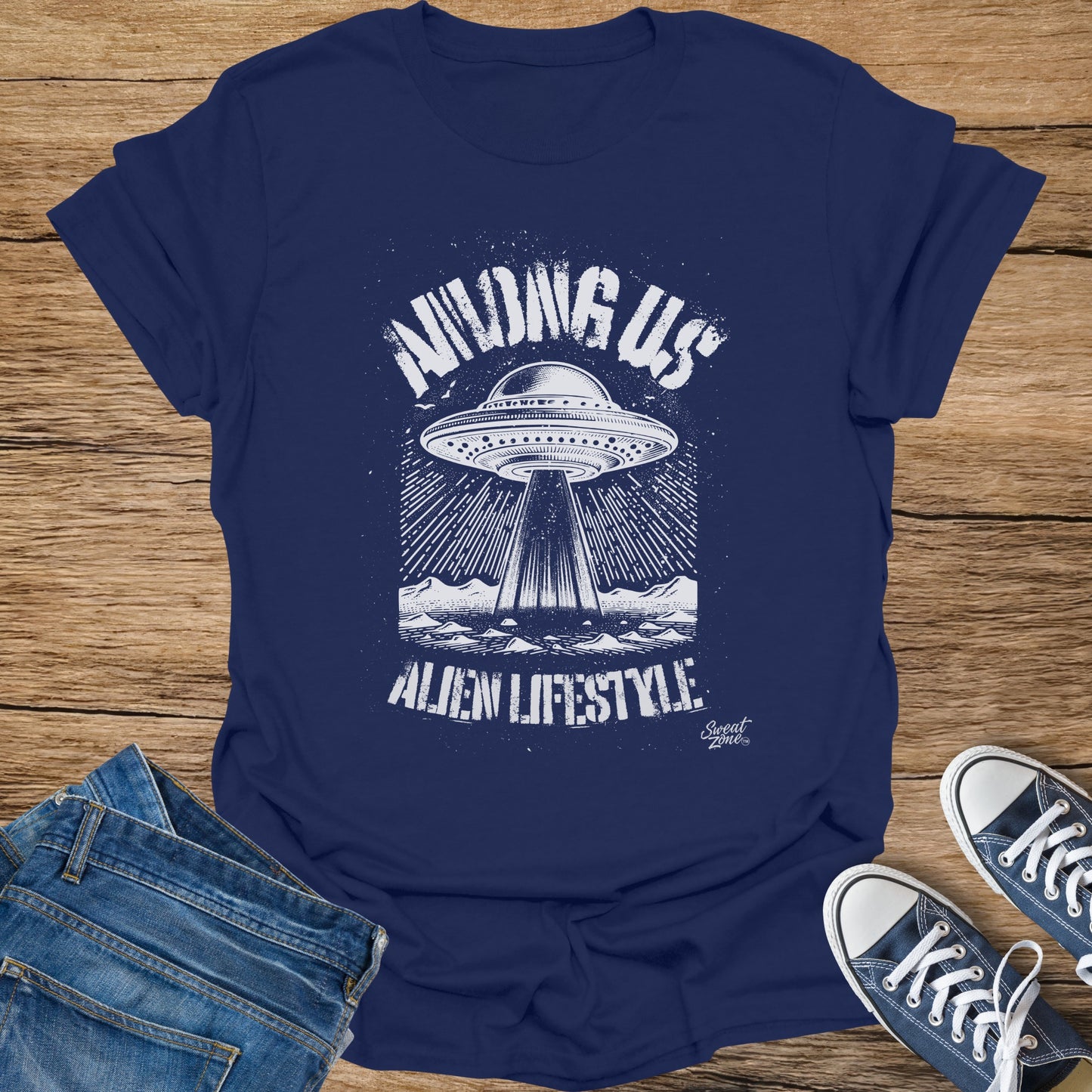 Navy t-shirt with white graphic of a UFO beaming down on mountains, reads "Among Us Alien Lifestyle".