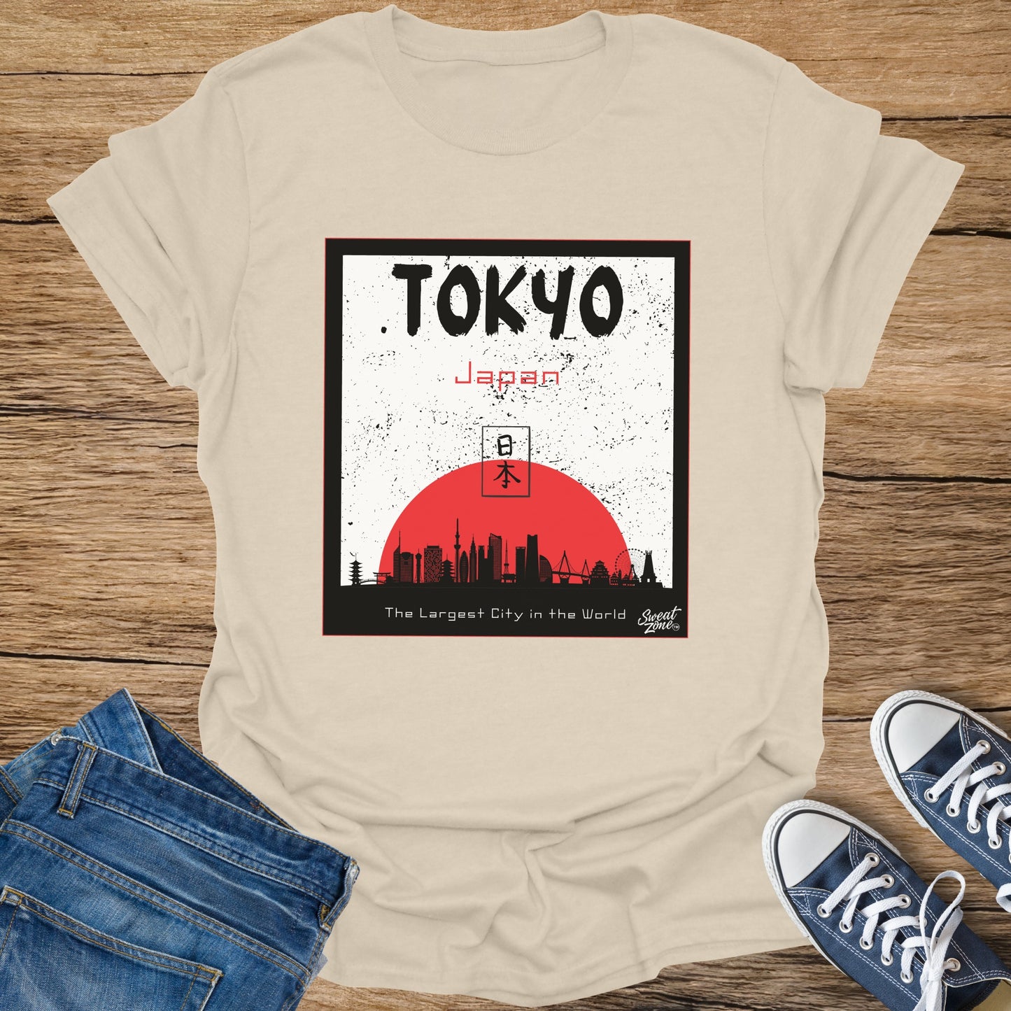 Cream t-shirt with graphic of Tokyo skyline, Japanese text, and sun.