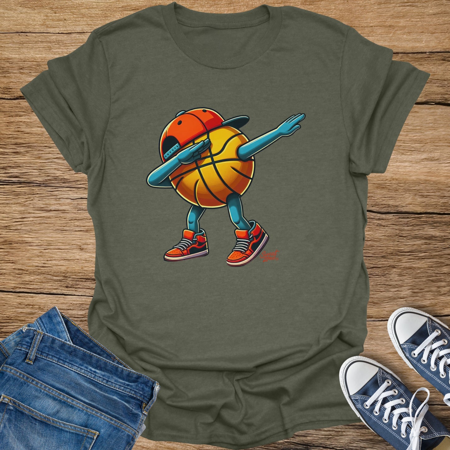 Green t-shirt with a cartoon basketball doing the dab dance.