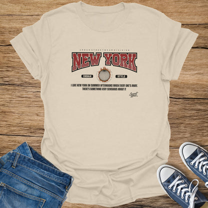 Cream t-shirt with "New York" graphic and slogan, laid out with jeans and sneakers.