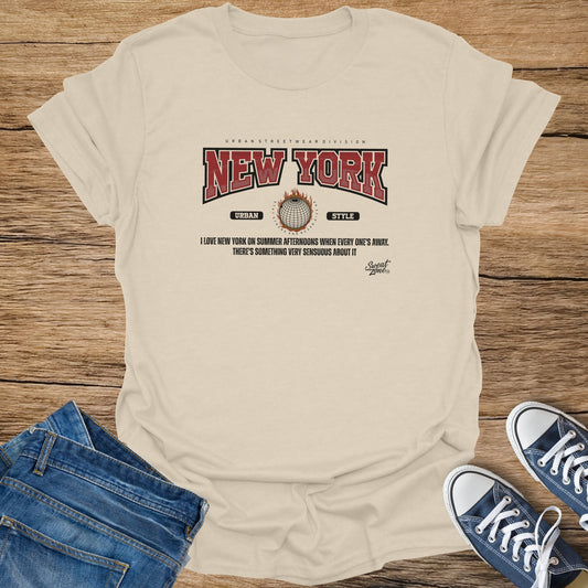 Cream t-shirt with "New York" graphic and slogan, laid out with jeans and sneakers.