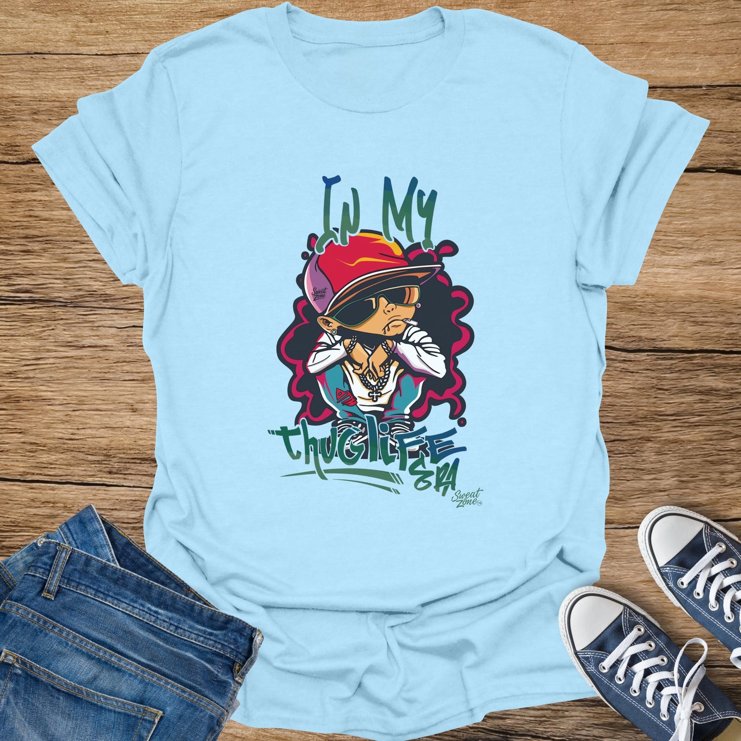 Light blue t-shirt with cartoon drawing and "thuglife" text.