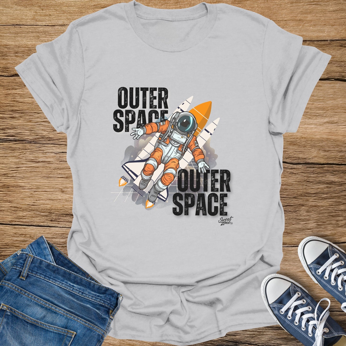 Light gray t-shirt with astronaut and rockets graphic, bold "Outer Space" text.