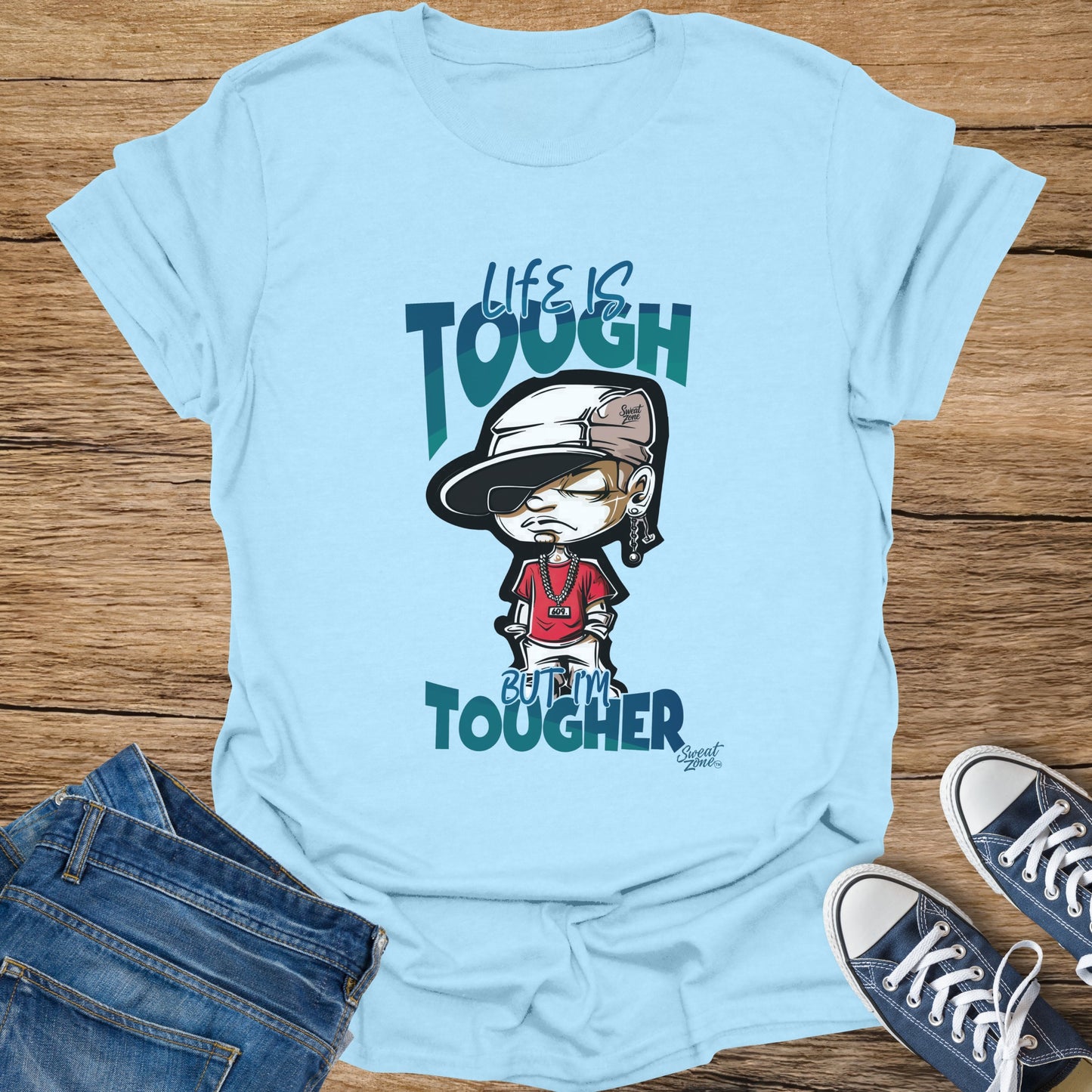 Pale blue t-shirt with cartoon character and text "Life is tough but I'm tougher".