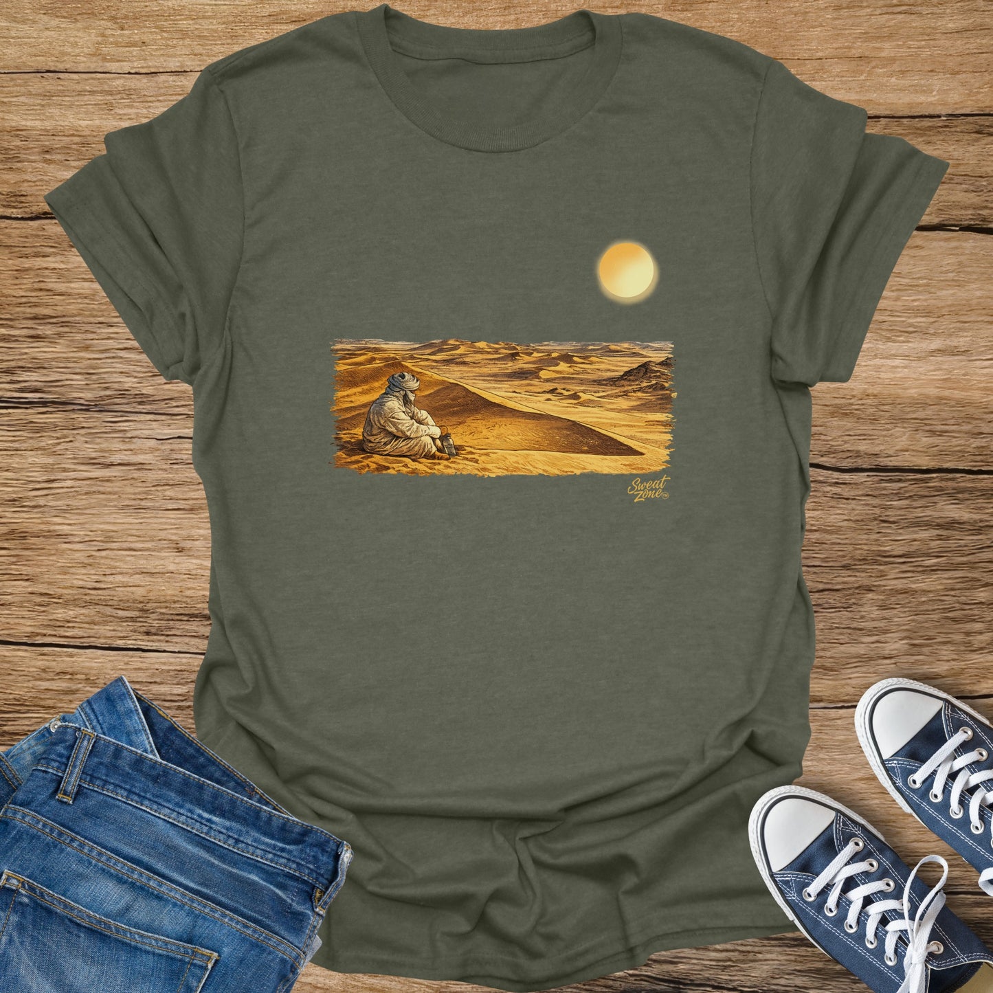T-shirt with illustration of person in desert with sun and "Sweat Zone" logo.