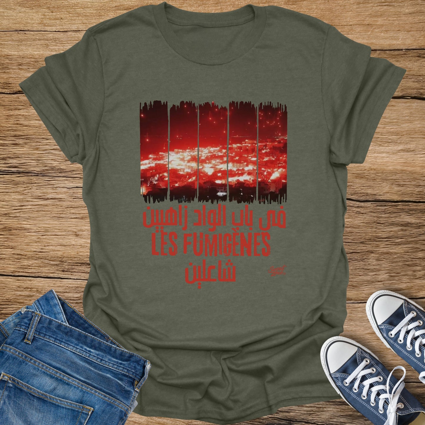 Dark green t-shirt with red text and abstract red and white graphics.