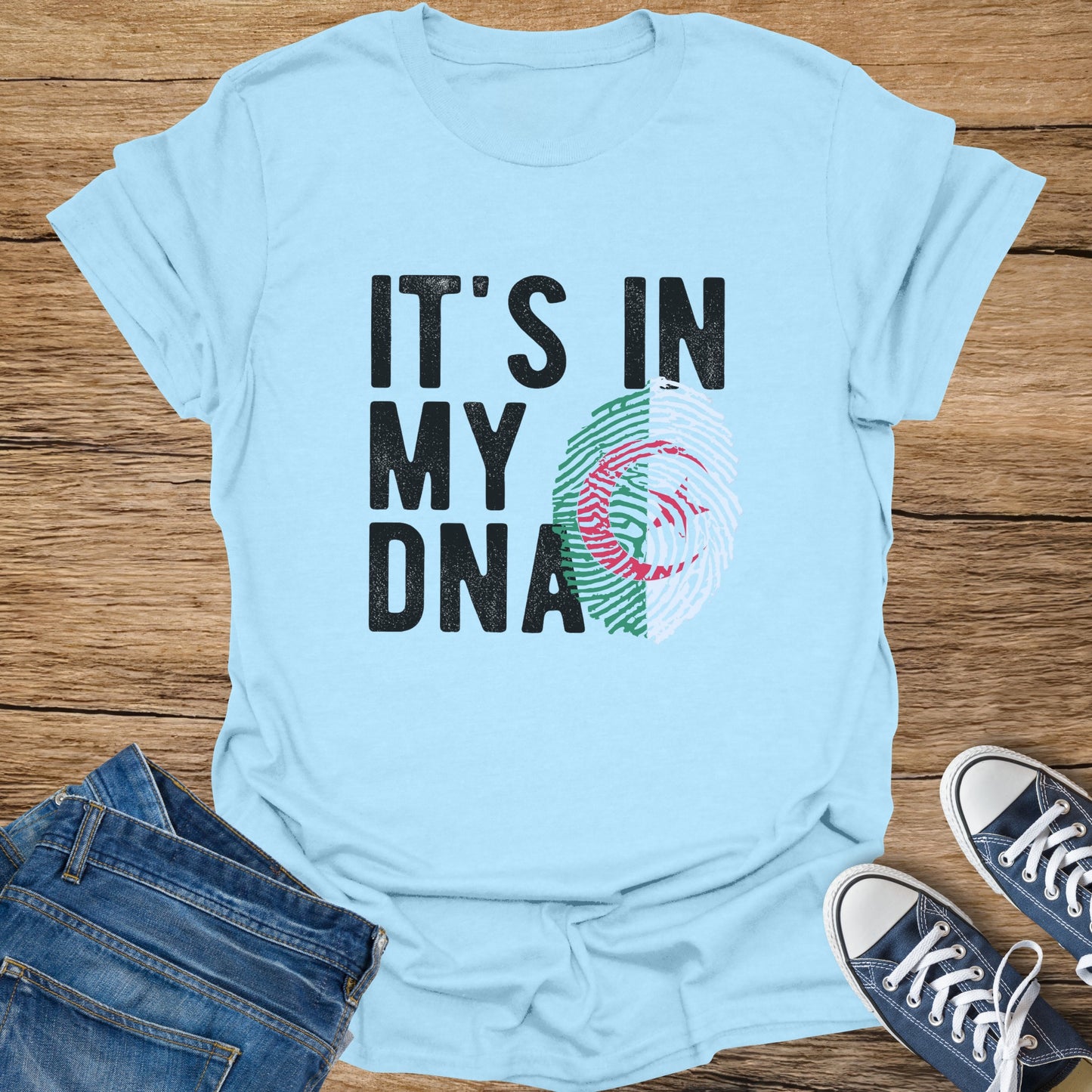 Light blue t-shirt with "IT'S IN MY DNA" and an Algerian flag fingerprint.