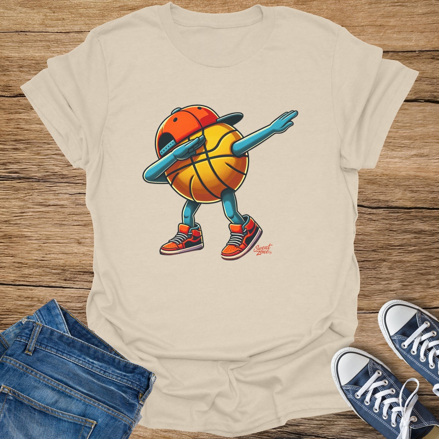 T-shirt with a cartoon basketball character doing a dab dance in a baseball cap.