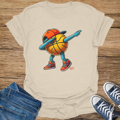 T-shirt with a cartoon basketball character doing a dab dance in a baseball cap.