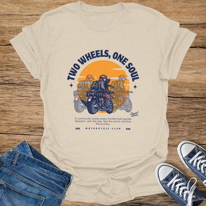 Cream t-shirt with "Two Wheels, One Soul" and motorcycle club graphic.