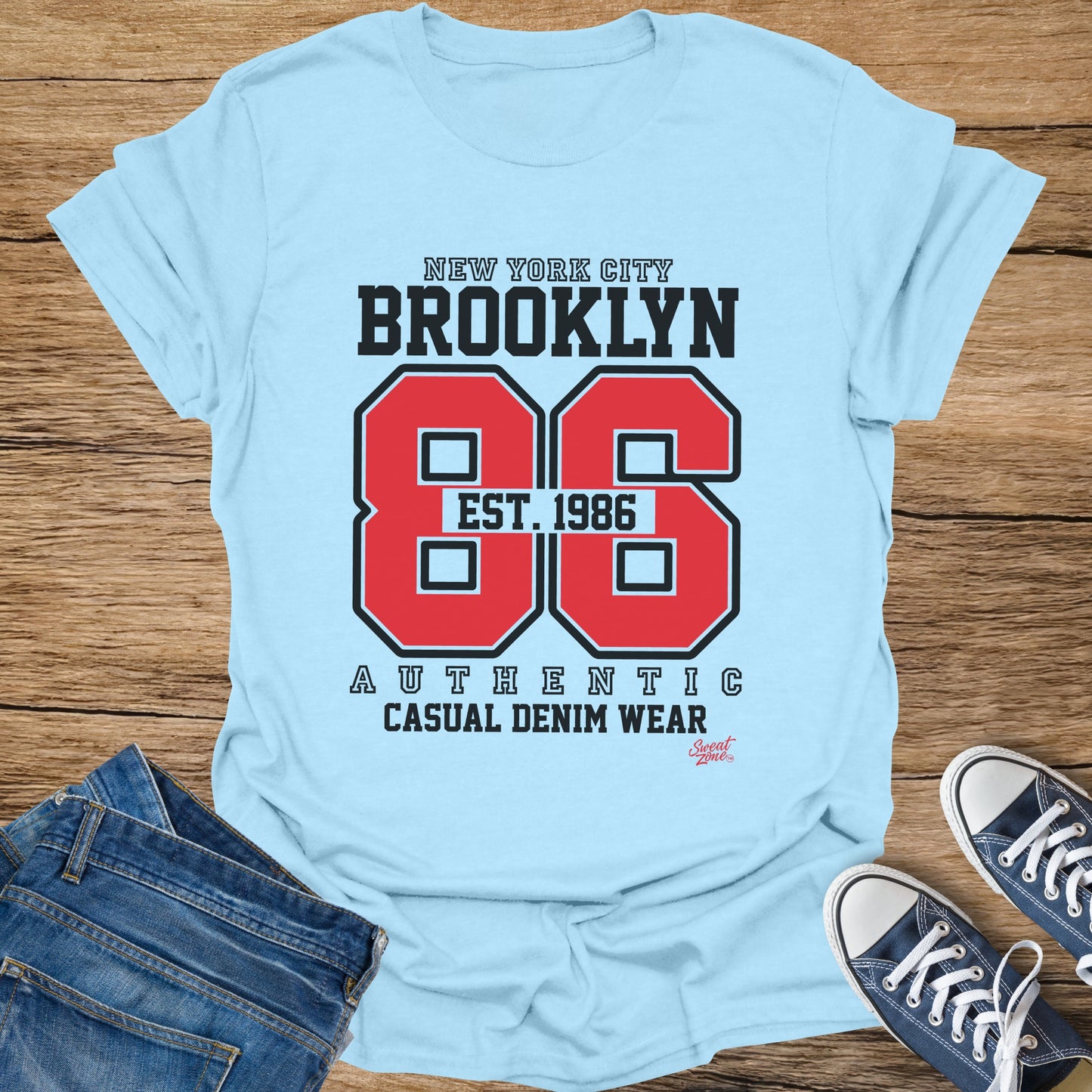 Light blue t-shirt with Brooklyn 86 Est. 1986 Authentic Casual Denim Wear text.