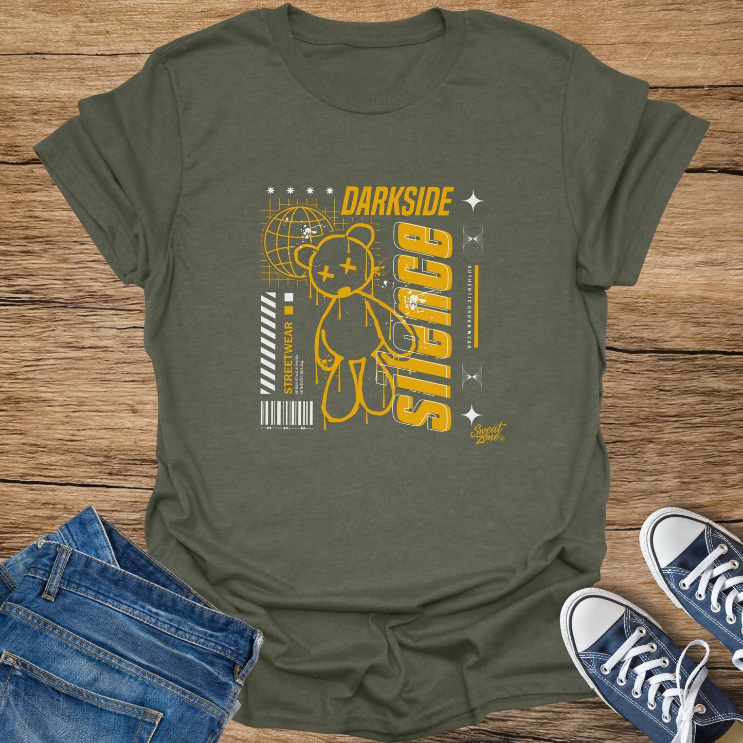 Olive t-shirt with yellow graphic of a teddy bear, globe, and text "DARK SIDE SILENCE".