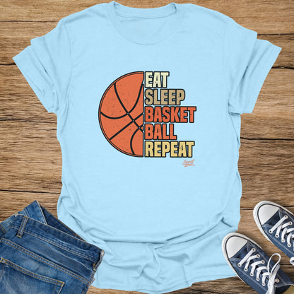 Light blue t-shirt with "Eat Sleep Basket Ball Repeat" graphic and basketball.