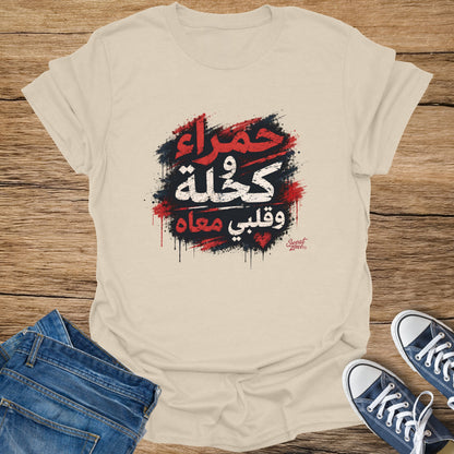 Cream t-shirt with Arabic text and paint splatters, plus jeans and blue sneakers.