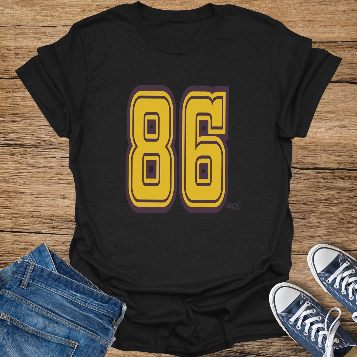 Black t-shirt with large yellow number 86 and "Sweat Zone" logo.