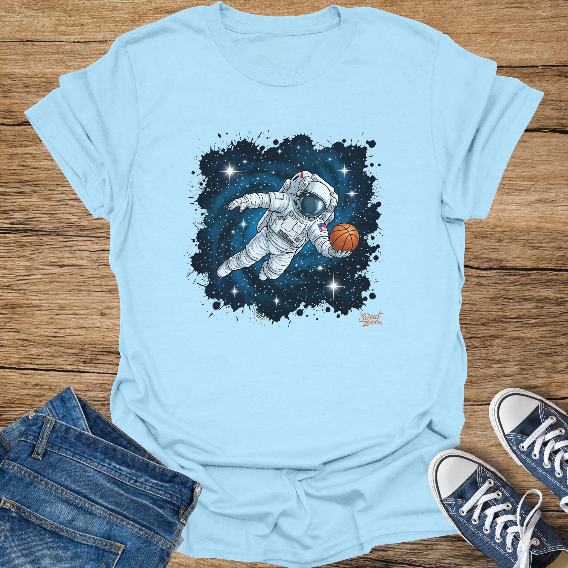 Astronaut floating in space holding a basketball with stars and splatter.