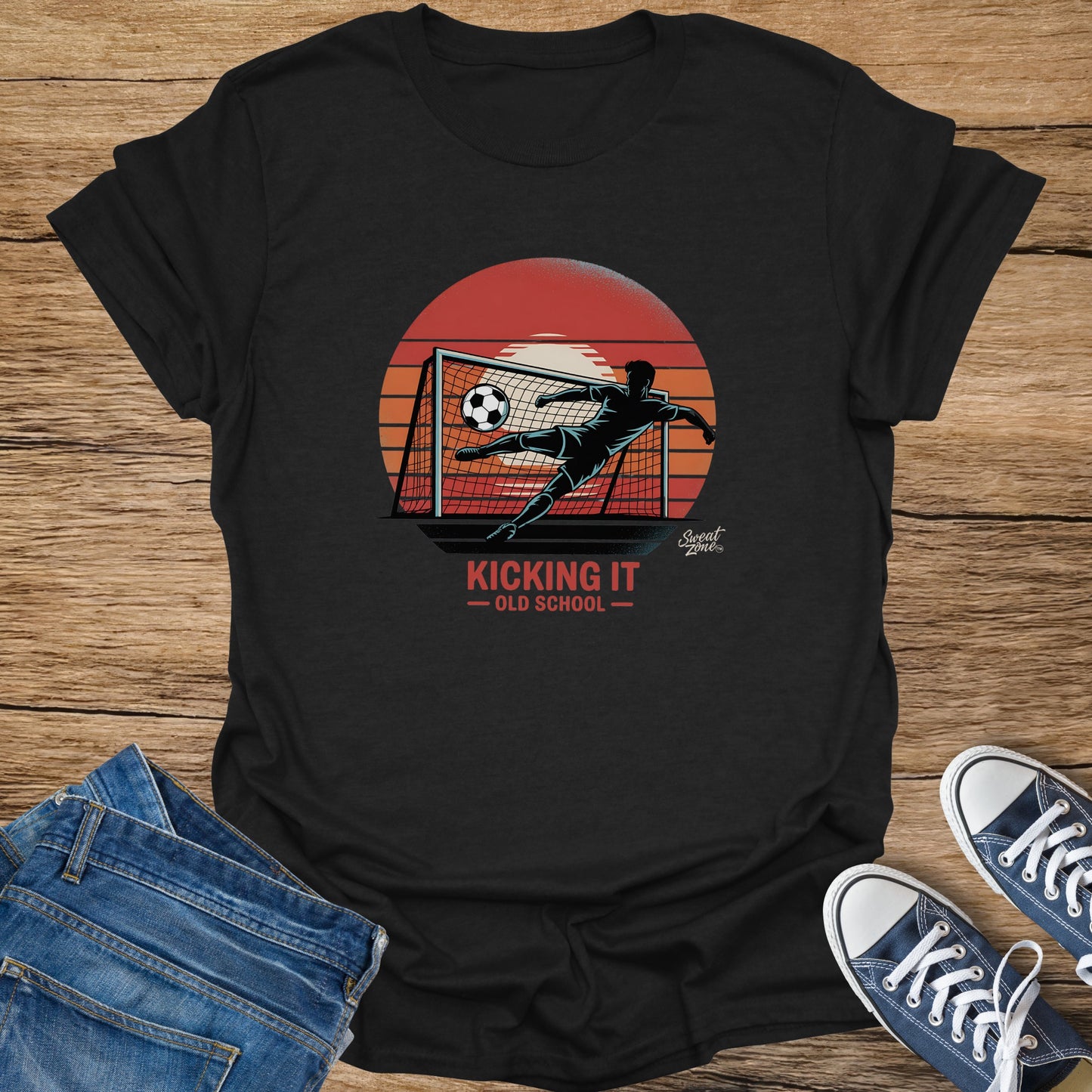 Black t-shirt with soccer player kicking ball into net under sunset. "Kicking It - Old School" text.