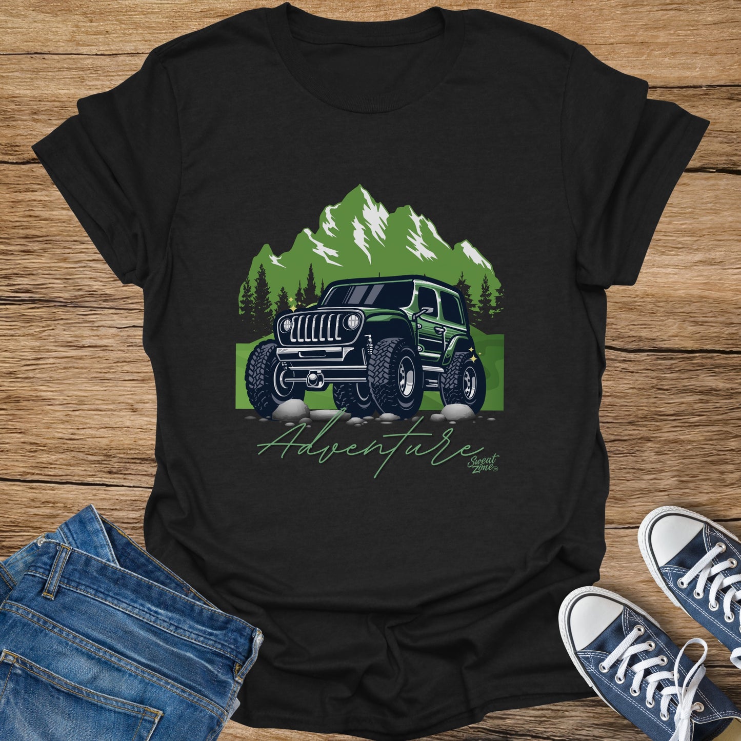 Black t-shirt with a green off-road vehicle and mountains graphic and "Adventure" text.