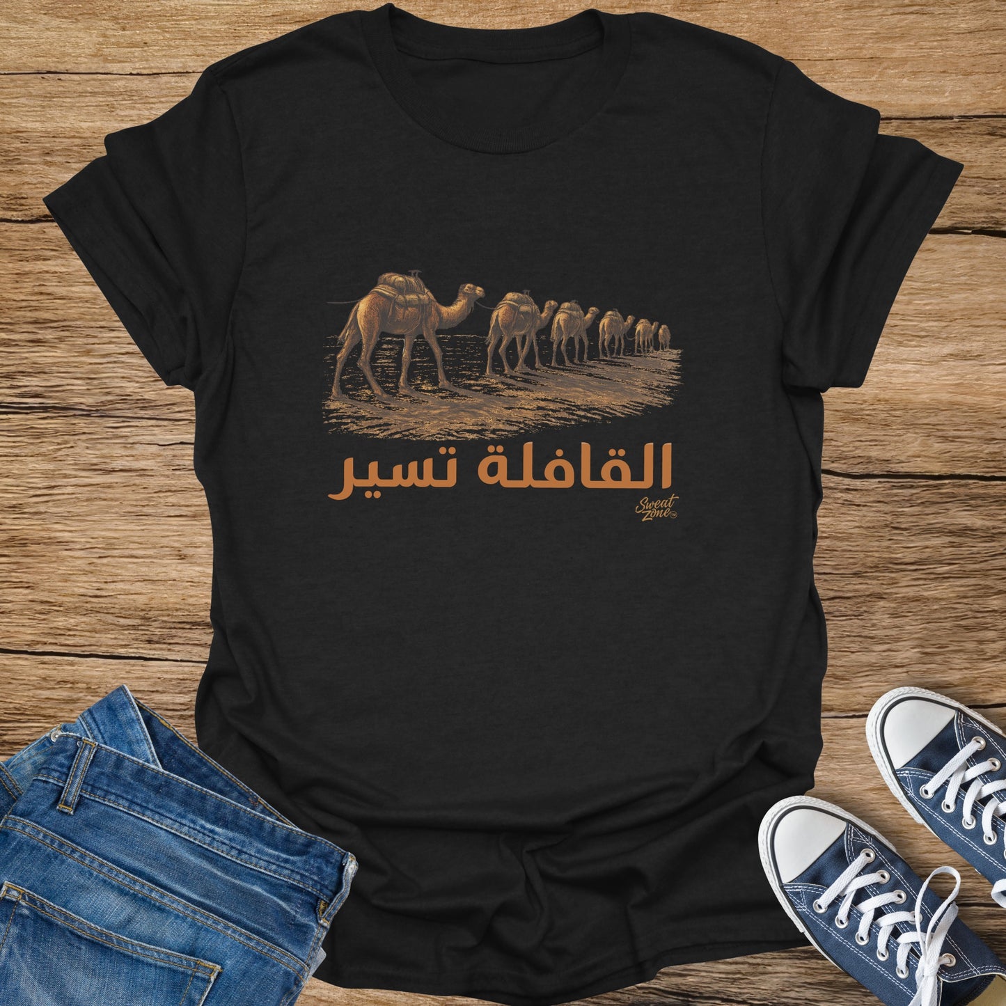 Black t-shirt with a caravan of camels and Arabic text.