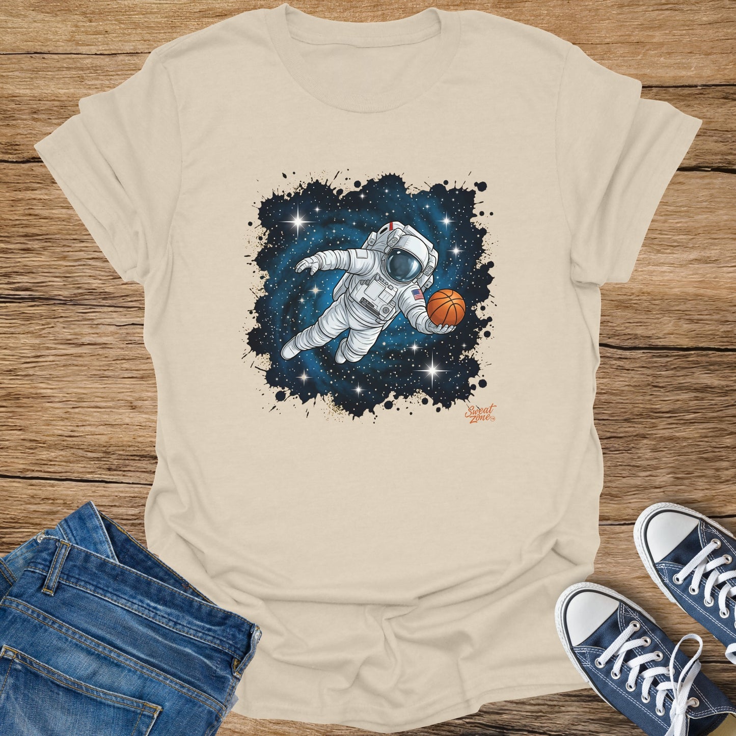 Astronaut floating in space holding a basketball with stars and paint splatters.