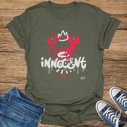 Green t-shirt with a graffiti-style red and white skull graphic and "INNOCENT" text.